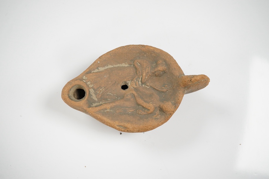 An Ancient Greek 'Athens' terracotta oil lamp, 10cm. Condition - fair